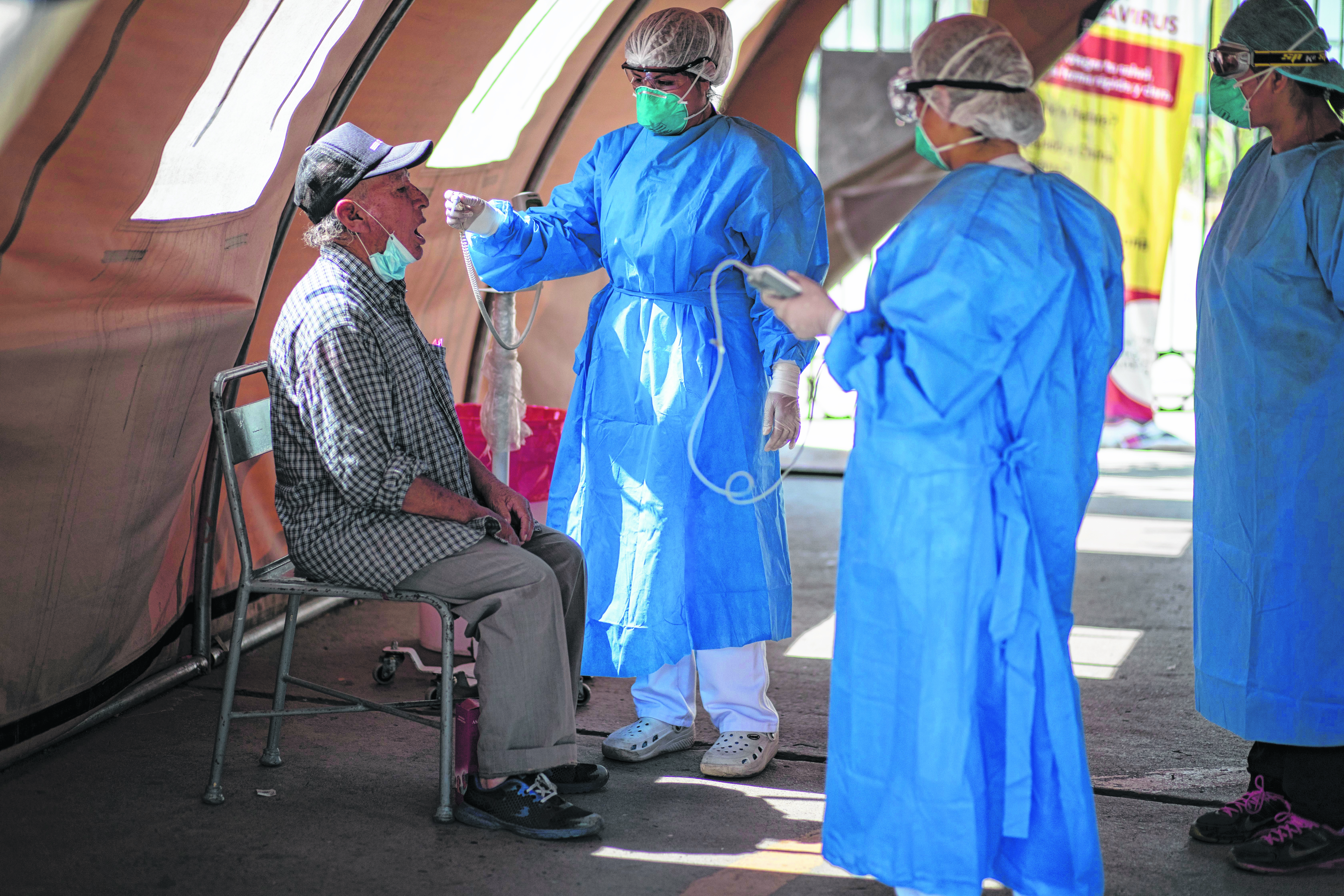 An elderly person is screened for the symptoms of the new coronavirus at a tent hospital set up in Lima, Peru, Tuesday, April 7, 2020. As the new coronavirus pandemic spreads the government of Peru has steadily tightened bans and lock-downs to slow its spread. (AP Photo/Rodrigo Abd). (AP Photo/Rodrigo Abd).