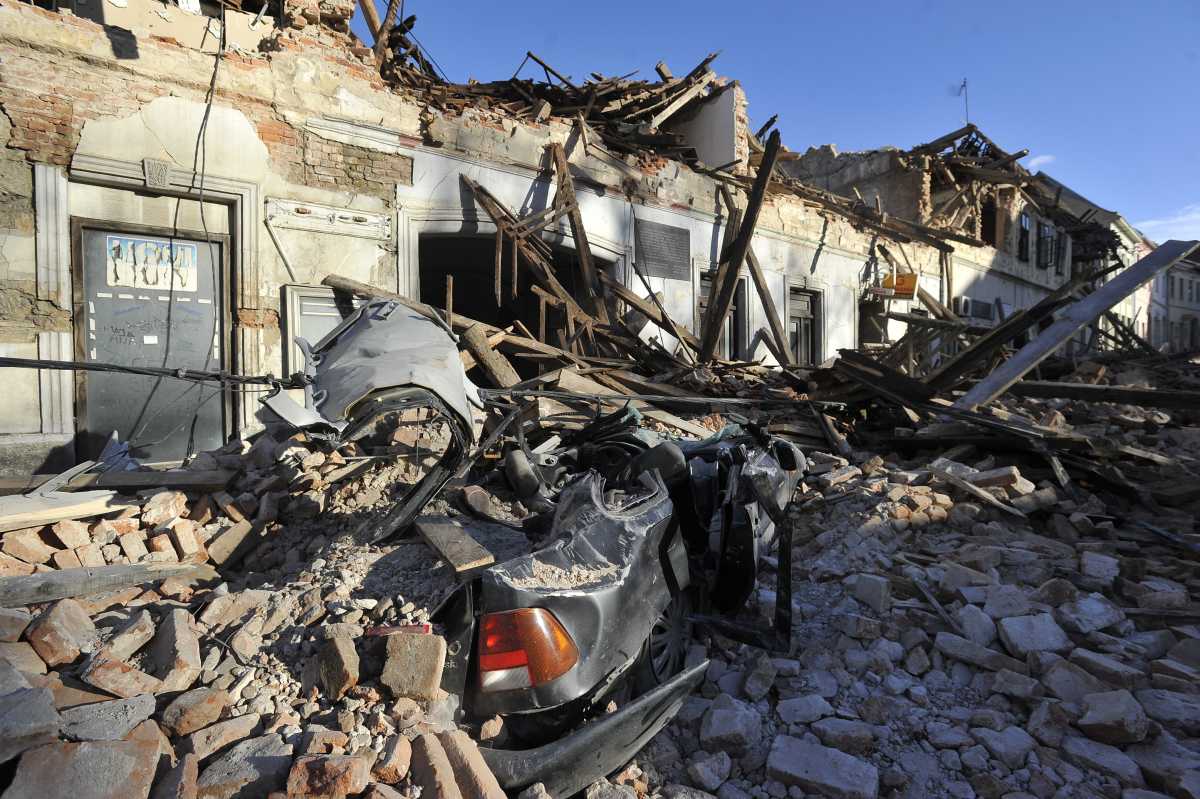 Restos de un auto cubierto por los escombros . Fotos AP 