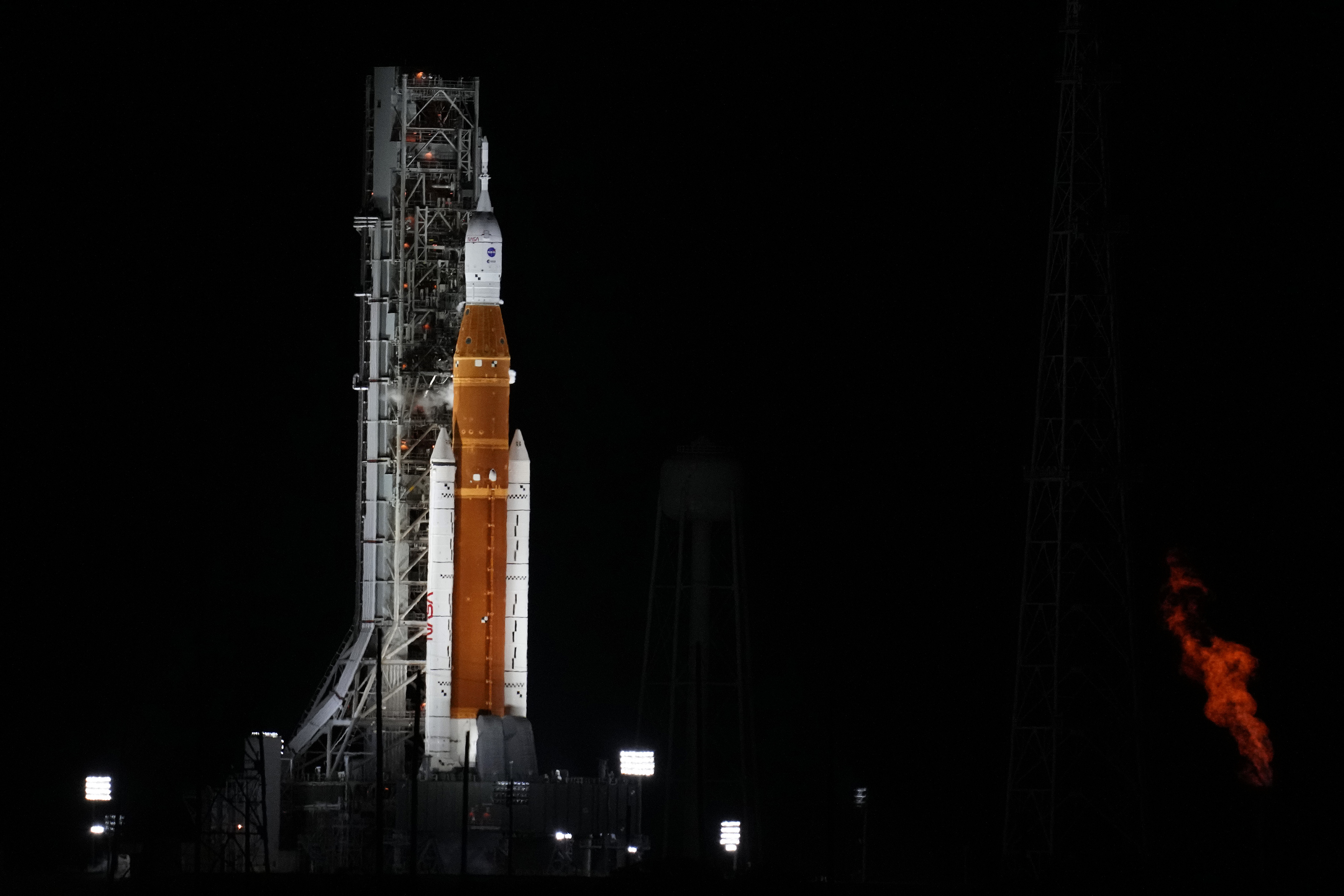 NASA's new moon rocket sits on Launch Pad 39-B hours before liftoff Monday, Aug. 29, 2022, in Cape Canaveral, Fla. This is scheduled to be the first flight of NASA's 21st-century moon-exploration program, named Artemis after Apollo's mythological twin sister. (AP Photo/Chris O'Meara)