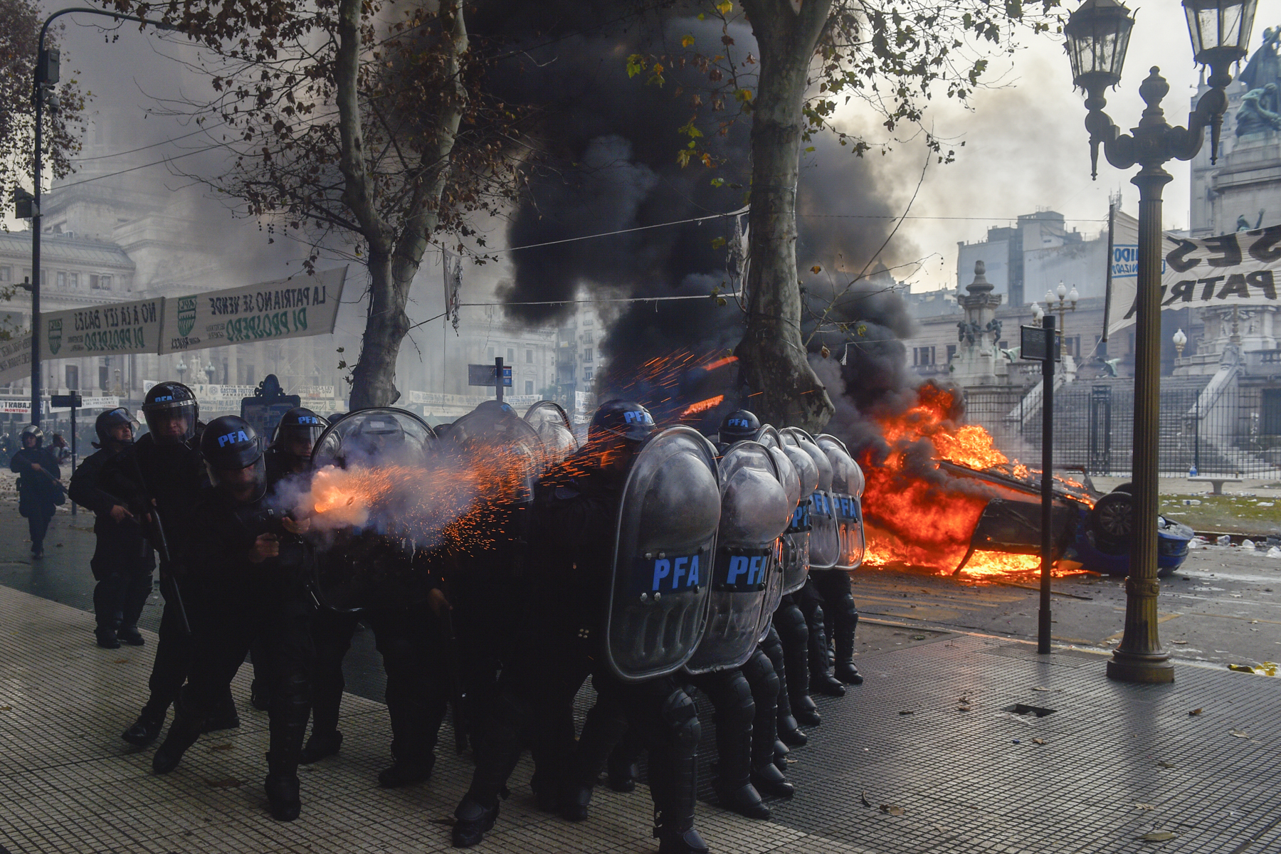 Police fire tear gas at anti-government protesters outside Congress, where lawmakers debate a reform bill promoted by Argentine President Javier Milei in Buenos Aires, Argentina, Wednesday, June 12, 2024. (AP Photo/Gustavo Garello)